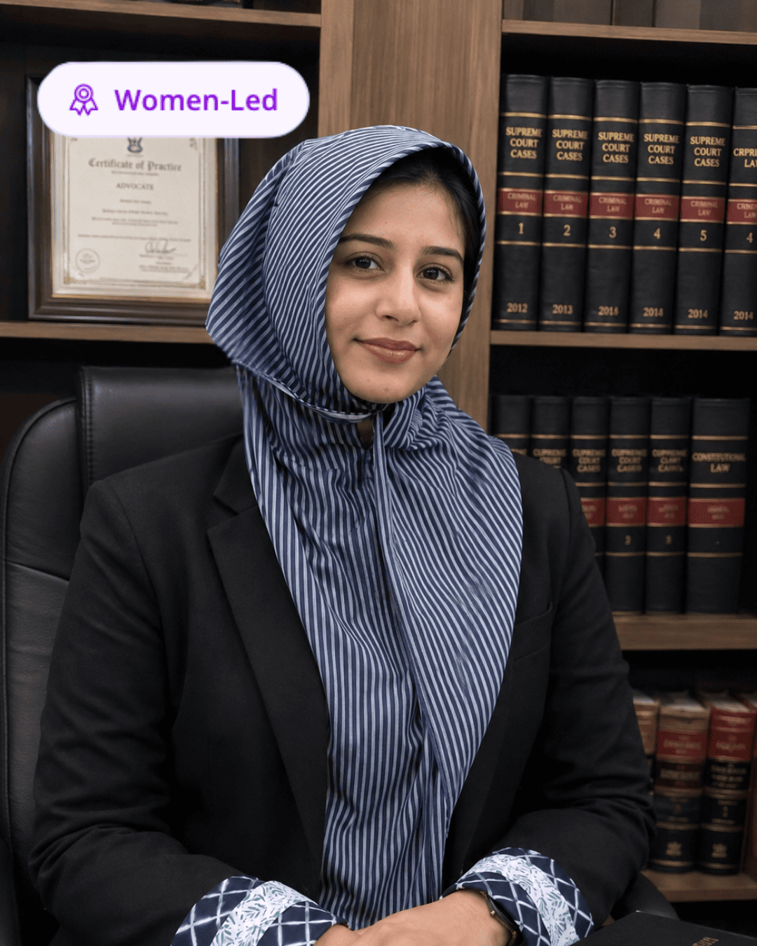 Advocate Nisrin Dammerwala at her desk in front of law books