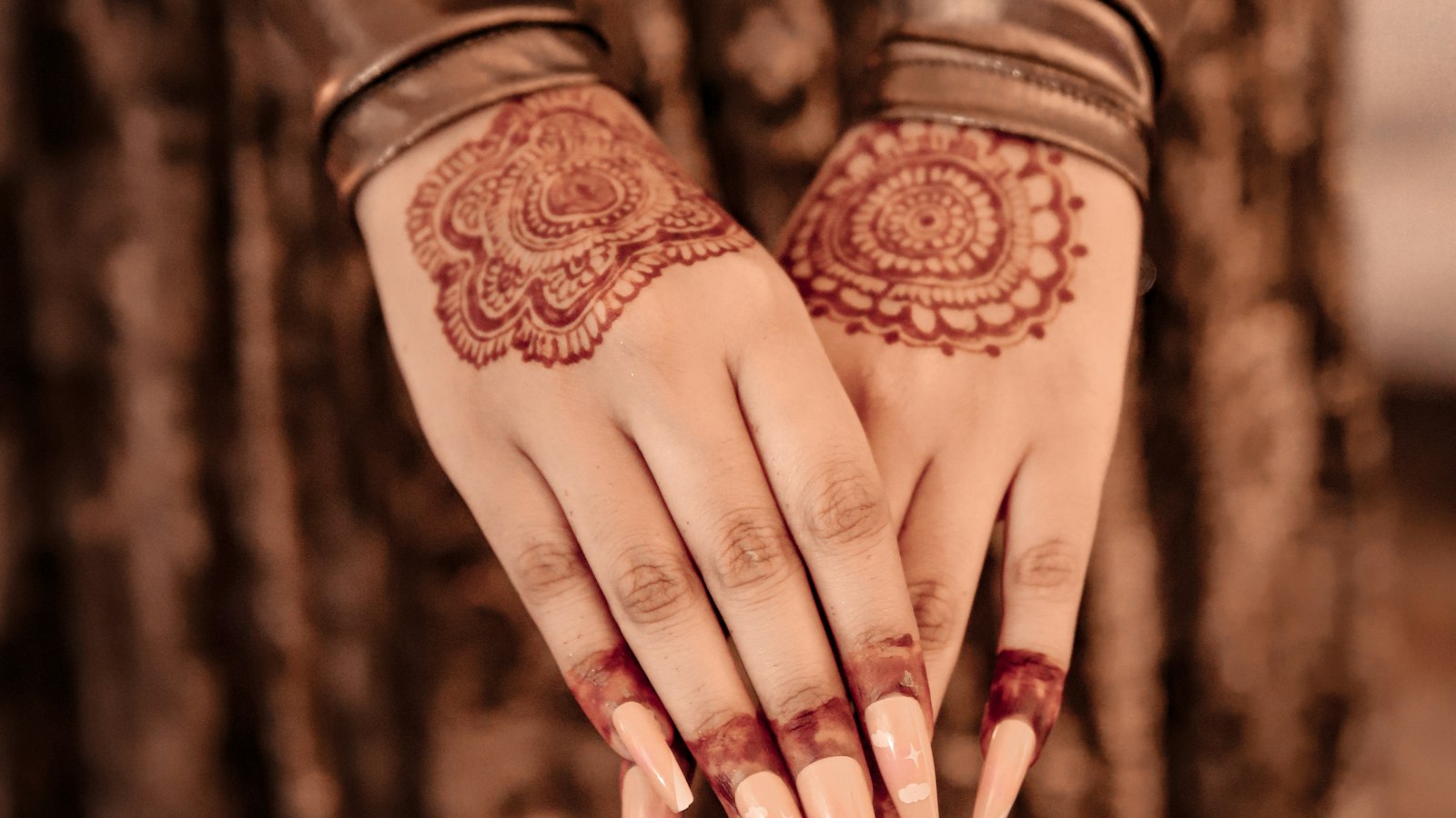 Hands decorated with intricate bridal mehndi designs